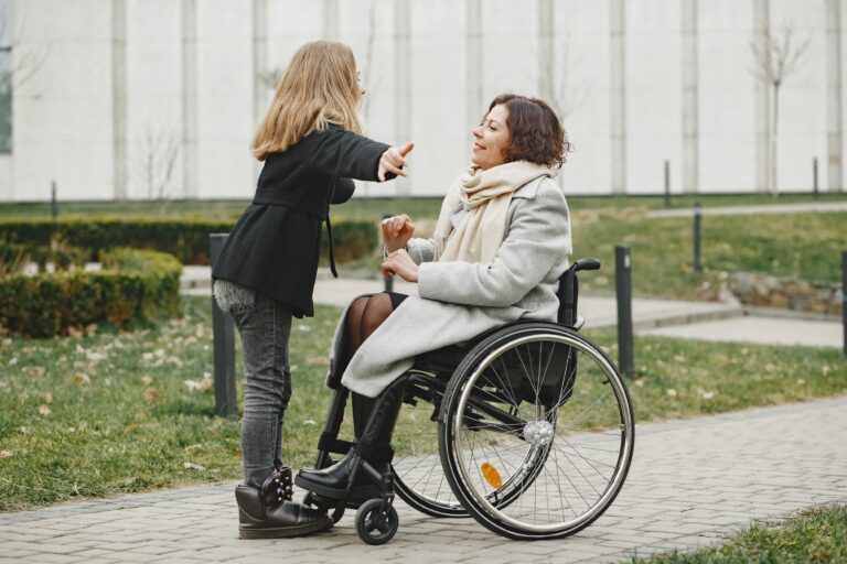 Photo of woman in wheelchair chatting with young woman. Image credit pexels-gustavo-fring-6284853.jpg